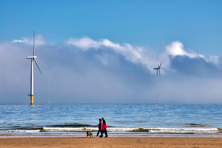 grieving couple stroll on beach